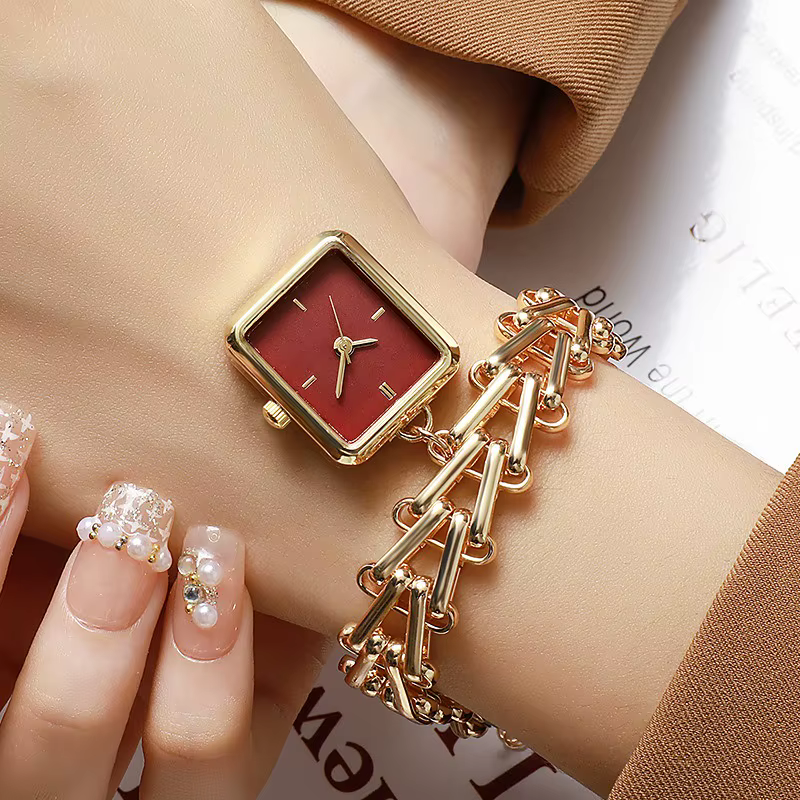 Montre de luxe dorée avec cadran triangulaire motif épi de blé