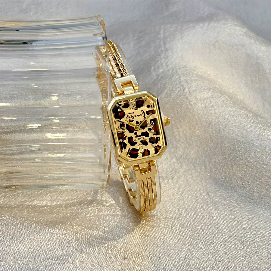 Montre-bracelet rectangulaire dorée pour femme avec chaînes à pampilles